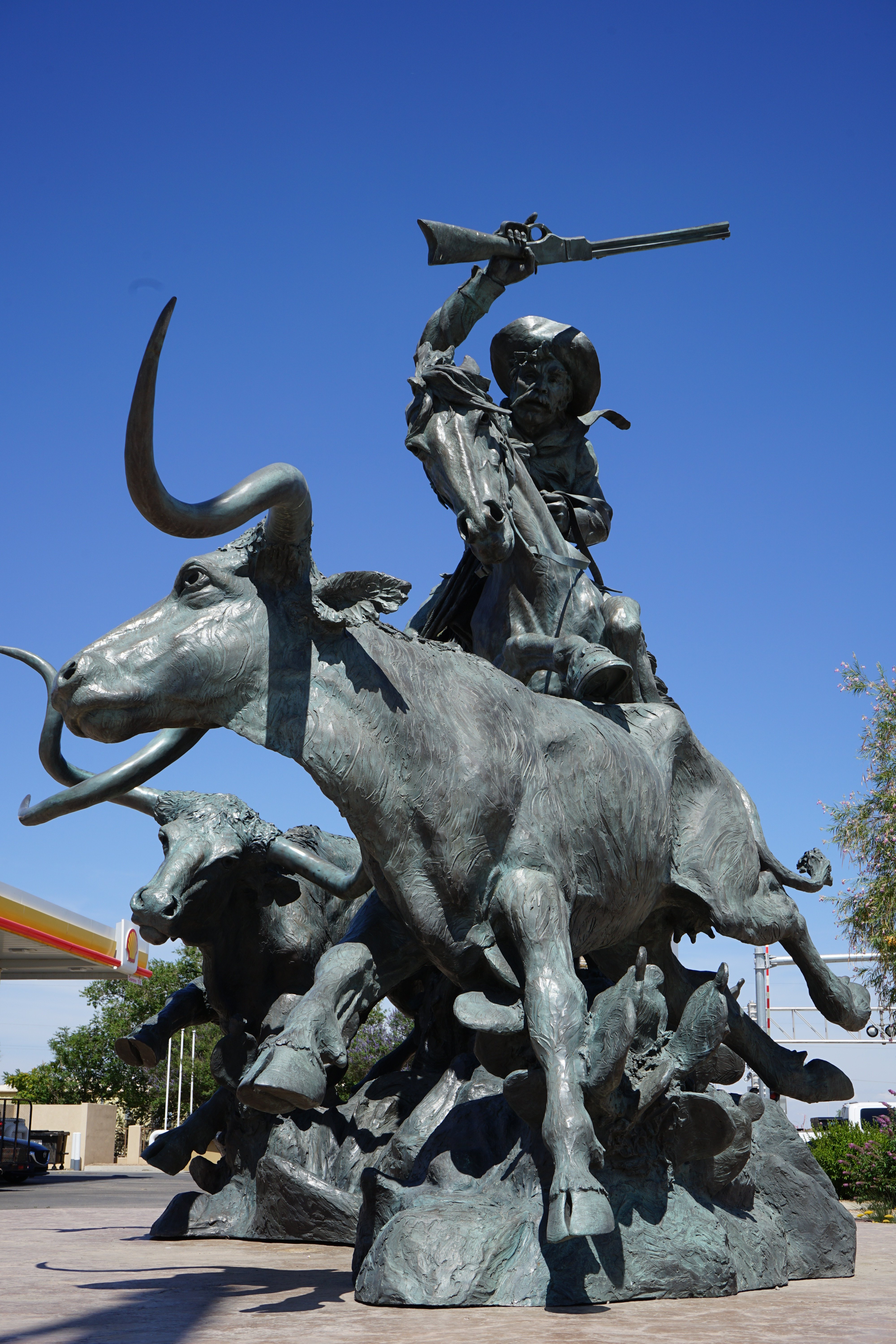 Bronze statue of a cowboy on a bull with another bull